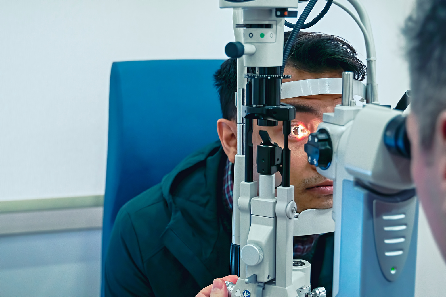 Eye doctor examining patient eyes after LASIK surgery